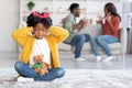 Family Conflicts. Upset Black Girl Closing Ears With Hands While Parents Arguing