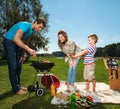 Family cooking on a grill outdoors