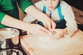 Family cooking home - hands of mother and son kneading dough Royalty Free Stock Photo