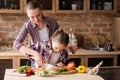 Family cooking mother teach daughter cut vegetable