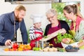 Family cooking in multigenerational household with son, mother, Royalty Free Stock Photo