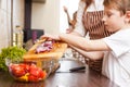 Family cooking. Mum and children in the kitchen Royalty Free Stock Photo