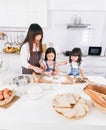Family cooking time Happy mother and two dauther help cooking bake together in kitchen at home