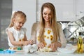 Family Cooking. Woman With Child Baking At Home