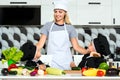 A family of cooks.Healthy eating.Mother and children prepares vegetable salad in kitchen. Royalty Free Stock Photo