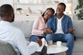 Family Counseling. Young Happy Black Couple Sitting On Couch At Psychotherapist`s Office