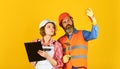 Family counting finances for renovation. Couple looking at documents. Woman and man wear safety hard hat. Redevelopment Royalty Free Stock Photo