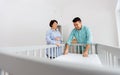 Family couple arranging baby bed with mattress Royalty Free Stock Photo