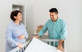 Family couple arranging baby bed with mattress Royalty Free Stock Photo