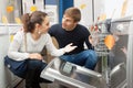 Family couple at household appliances store