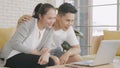 Family couple husband and wife laughing sitting on sofa using laptop computer webcam Royalty Free Stock Photo