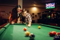 Family couple plays in billiard room Royalty Free Stock Photo