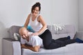 Family couple smiling ans hugging sitting on sofa Royalty Free Stock Photo