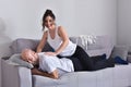 Family couple smiling ans hugging sitting on sofa Royalty Free Stock Photo