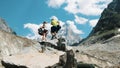 Family couple of tourists with backpacks in the hike to remove rucksacks on the top in the mountains. Royalty Free Stock Photo