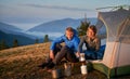 Morning coffee break in camp of married couple in the mountains. Royalty Free Stock Photo