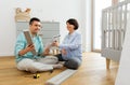 Family couple with user manual assembling baby bed Royalty Free Stock Photo