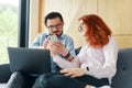 Family couple using laptop and smartphone for reading and discussing morning news or online work Royalty Free Stock Photo