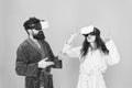 Family couple wear vr glasses. girl and man hipster relax in bathrobe. morning start with future technology. Another Royalty Free Stock Photo