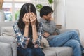 Family crisis. Asian wife crying on the sofa after husband cheating on her Royalty Free Stock Photo