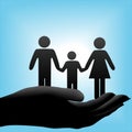Family in cupped hand on blue background