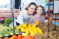 Family customers buying ripe fruits together Royalty Free Stock Photo