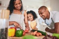 Family, cut and cooking vegetables together or learning chef skill with parents and child in kitchen. Nutrition, healthy Royalty Free Stock Photo