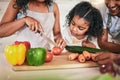 Family, cutting vegetables and cooking together, learning chef skill with parents and child in kitchen. Nutrition Royalty Free Stock Photo