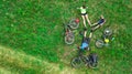 Family cycling on bikes aerial view from above, happy active parents with child have fun and relax on grass, family sport Royalty Free Stock Photo