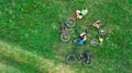 Family cycling on bikes aerial view from above, happy active parents with child have fun and relax on grass, family sport Royalty Free Stock Photo
