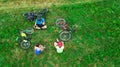 Family cycling on bikes aerial view from above, happy active parents with child have fun and relax on grass, family sport Royalty Free Stock Photo