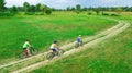 Family cycling on bikes outdoors aerial view from above, happy active mother with children have fun