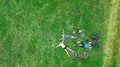 Family cycling on bikes outdoors aerial view from above, happy active parents with child have fun and relax on grass