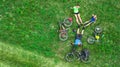 Family cycling on bikes outdoors aerial view from above, active parents with child have fun and relax on grass, family sport Royalty Free Stock Photo