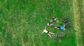 Family cycling on bikes outdoors aerial view from above, happy active parents with child have fun and relax on grass, family sport Royalty Free Stock Photo