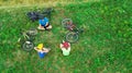 Family cycling on bikes outdoors aerial view from above, happy active parents with child have fun and relax on grass, family sport Royalty Free Stock Photo