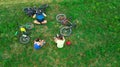 Family cycling on bikes outdoors aerial view from above, happy active parents with child have fun and relax on grass, family sport Royalty Free Stock Photo