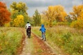 Family cycling in golden autumn park, active father and kids ride bikes, family sport and fitness with children Royalty Free Stock Photo