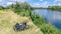 Family cycling outdoors, bicycles near river, aerial view of bikes and helmets from above, sport and fitness Royalty Free Stock Photo