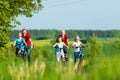 Family cycling outdoors in summer Royalty Free Stock Photo