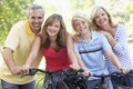 Family Cycling Through A Park Royalty Free Stock Photo