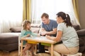 Family Dad, Mom and Little Daughter playing  board game together at home. Royalty Free Stock Photo