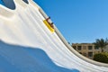 A family of dad and son ride a tubing on a fast water attraction in an aquapark Royalty Free Stock Photo