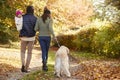Family With Daughter And Dog Enjoy Autumn Countryside Walk Royalty Free Stock Photo
