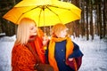 Family with daughter and mother in orange dress with yellow umbrella having fun and joy in woods, forest or park with Royalty Free Stock Photo