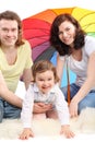 Family daughter are sitting under umbrella Royalty Free Stock Photo