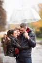 Family with daughter under the umbrellas Walk on rainy day. Royalty Free Stock Photo