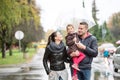 Family with daughter under the umbrellas Walk on rainy day. Royalty Free Stock Photo