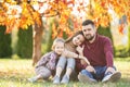 Family with daughter walks in autumn park