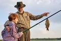 Family day. Lucky and skilled. Catching fish with grandfather. Experienced fishermen